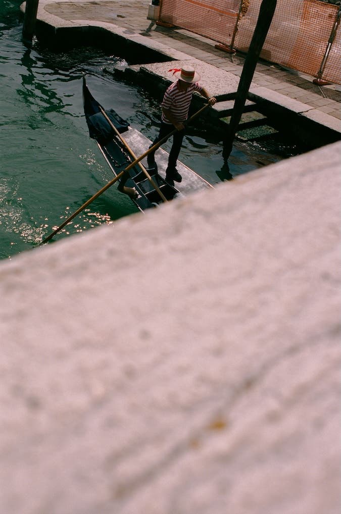a gondolier steering a boat in Venice