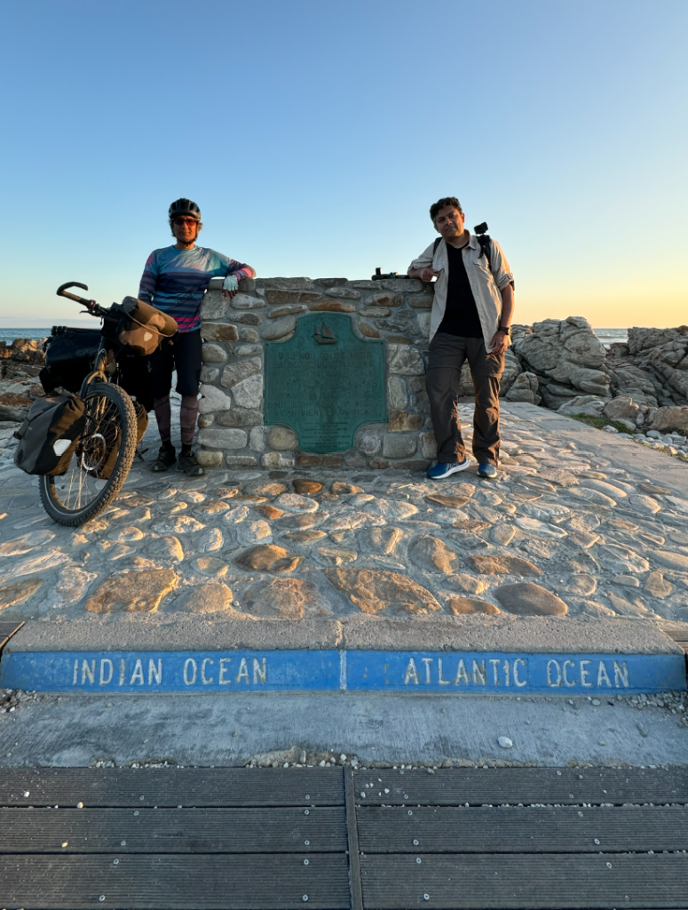 two men posing on the boundary of atlantic ocean and indian ocean
