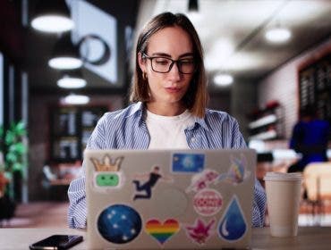 Art Class Student In Cafe Drinking Coffee And Studying On Laptop
