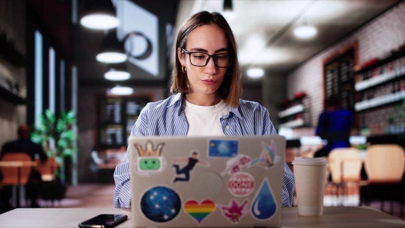 Art Class Student In Cafe Drinking Coffee And Studying On Laptop