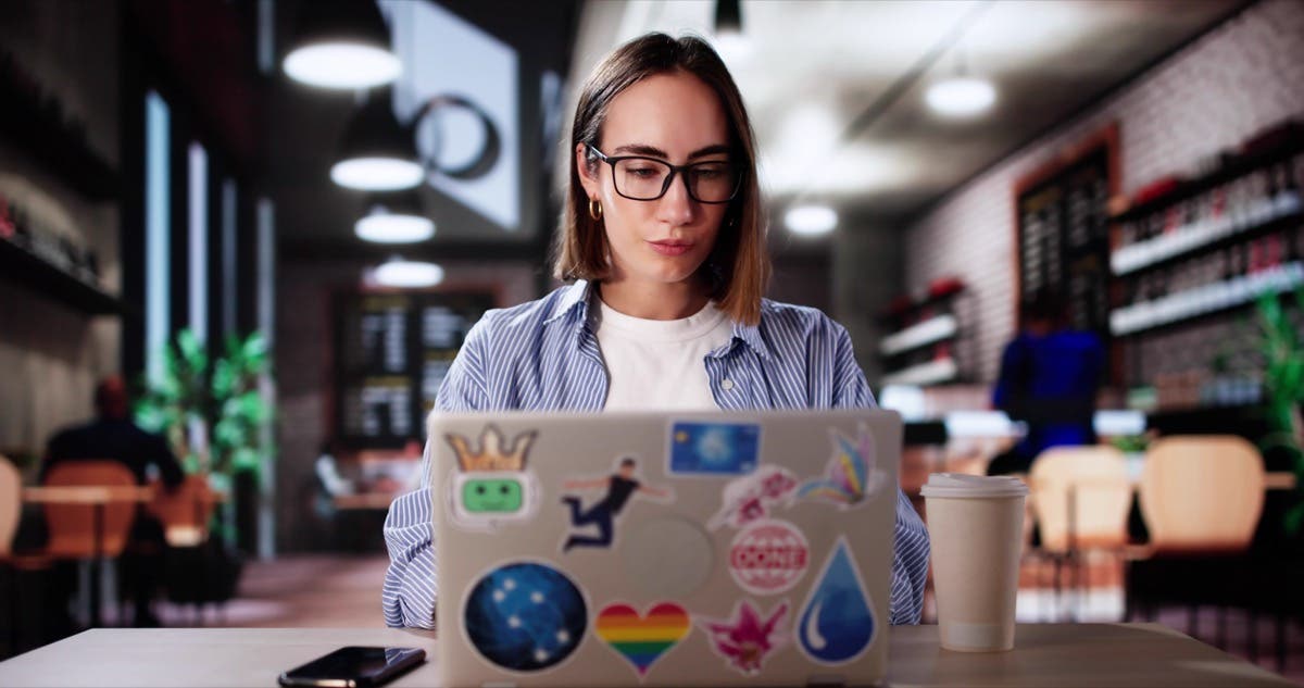 Art Class Student In Cafe Drinking Coffee And Studying On Laptop