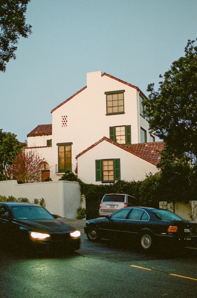 a white house lit by a sunset during springtime