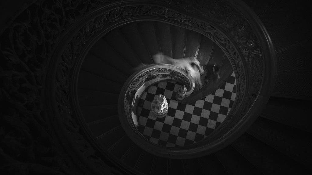 wedding couple walking down a spiral staircase