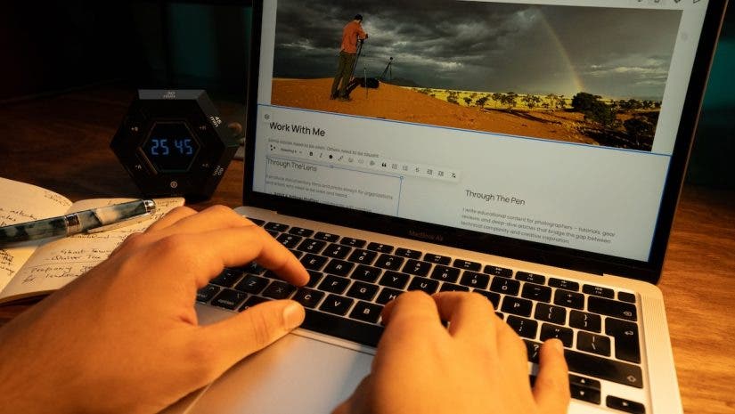 person typing on his laptop, building his photography website