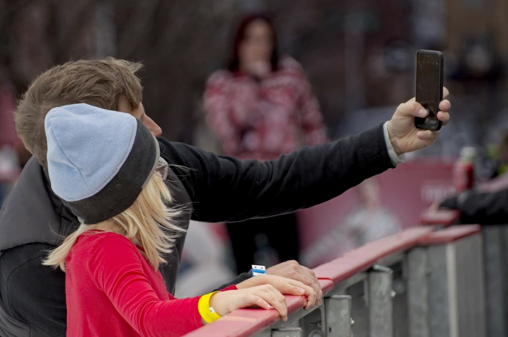 Photo of a parent and child taking a selfie