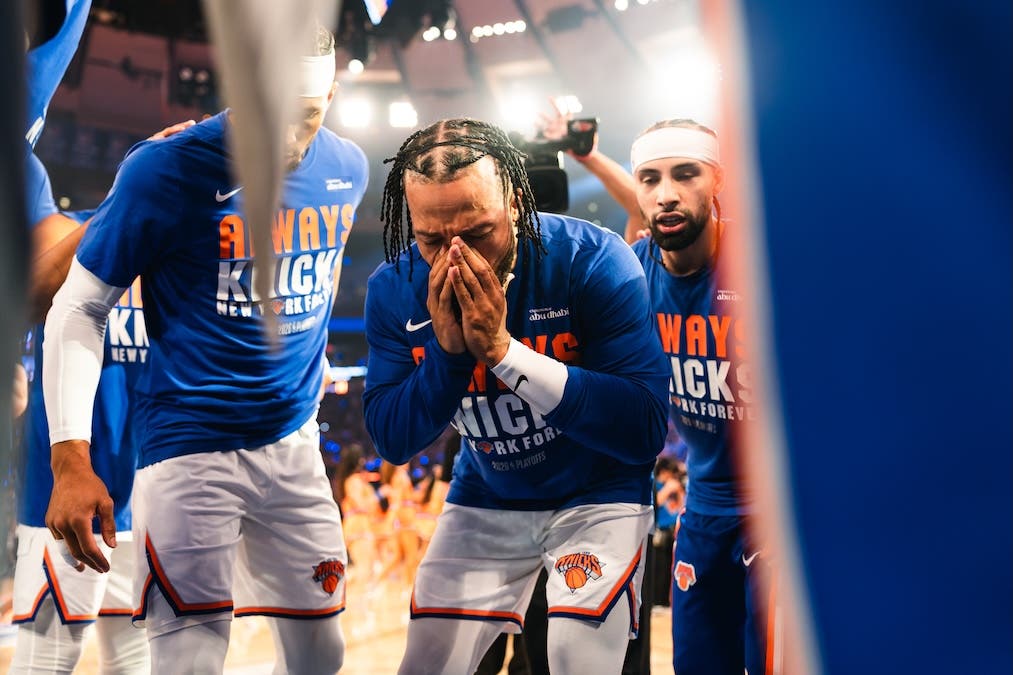 An emotional Jalen Brunson is surrounded by New York Knicks teammates during the playoffs against the Cleveland Cavaliers