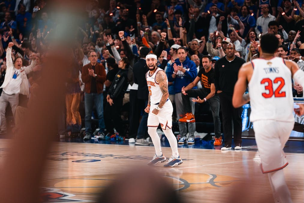 A New York Knicks player passionately celebrates on the court as the home crowd cheers during a game against the San Antonio Spurs
