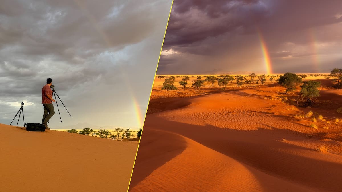 A split-screen composite image. The left panel shows a photographer viewed from behind, standing next to a camera on a tripod on a sand dune, looking out at a gray, overcast sky with a very faint rainbow. The right panel shows a vibrant, fully processed landscape of the same area: bright orange sand dunes, scattered green trees, dark dramatic storm clouds, and a brilliant, clear double rainbow.