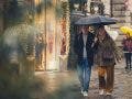A couple sharing a black umbrella on a rainy, festive city street lined with warm shop lights, captured candidly through foreground foliage by invisible street photographer Muji.