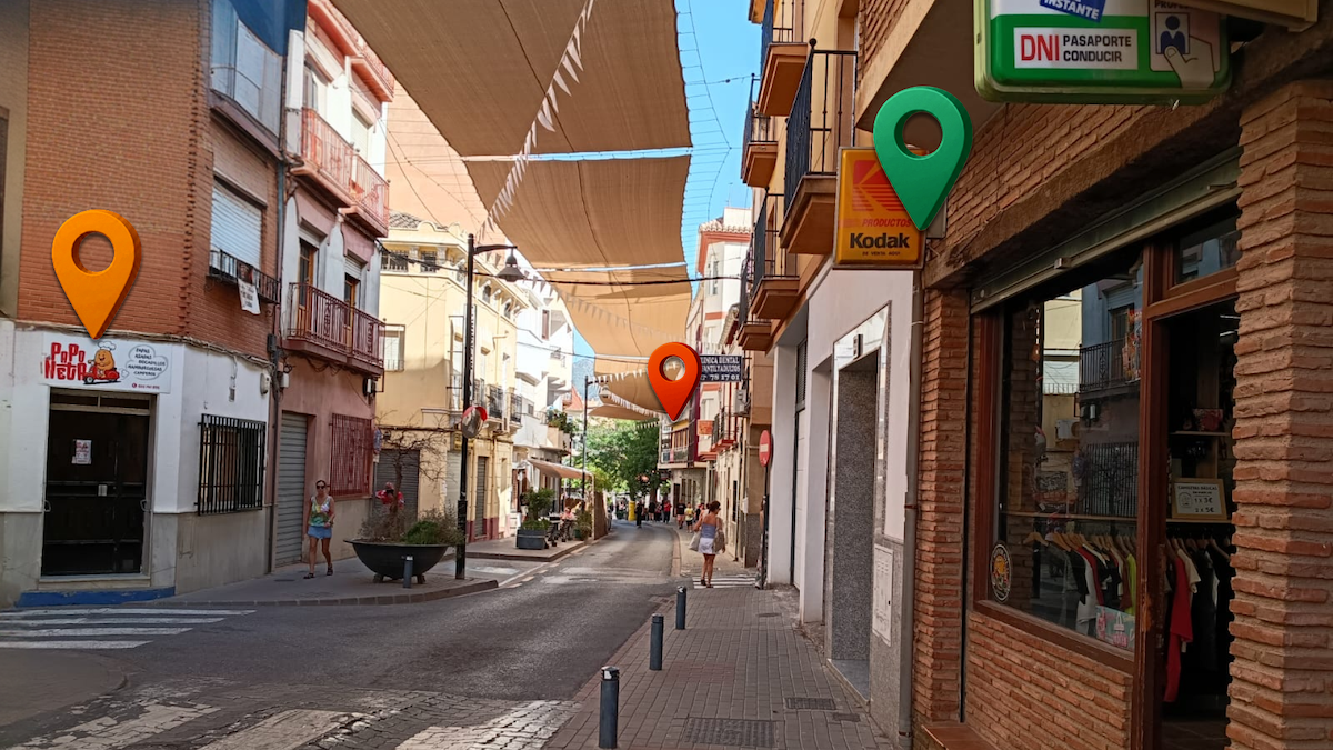 Street of local shops with three location pins marking three places to find photography clients