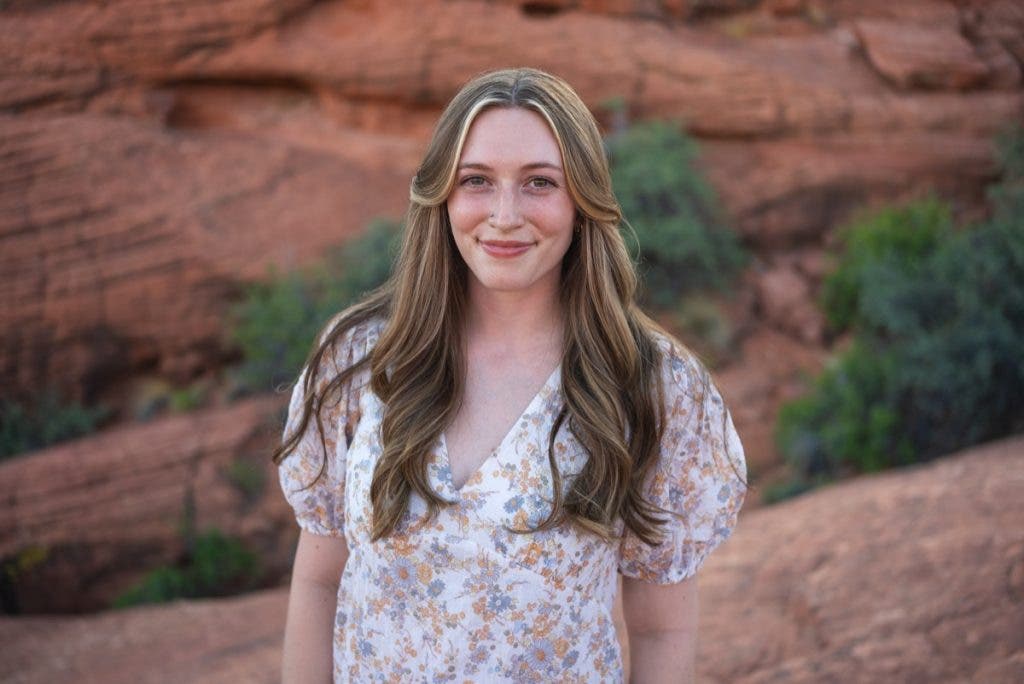 A wide aperture blurs the background behind the subject for a more compelling portrait. The subject is a young woman with brown hair.