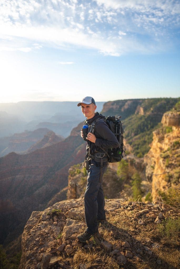 A photo of the author on a cliff. After setting my ISO to 100 and aperture to wide (f/1.4 on this lens), I changed the shutter speed until my image was properly exposed. With the sun hitting the scene, 1/2000s was the perfect choice.