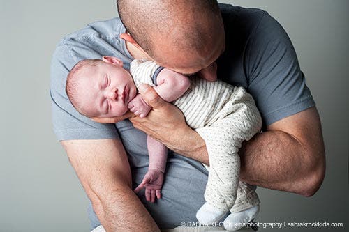Baby held by dad