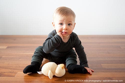 Baby with a plain white wall behind