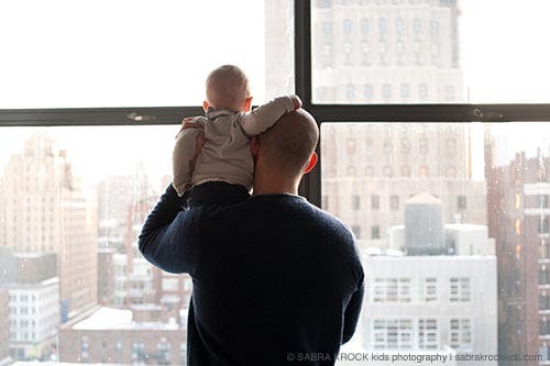 Dad and baby looking in the window