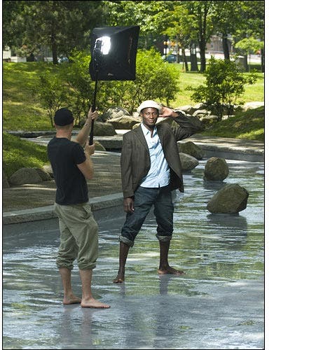 Man posing in water with light