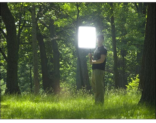 Man holding a light diffuser