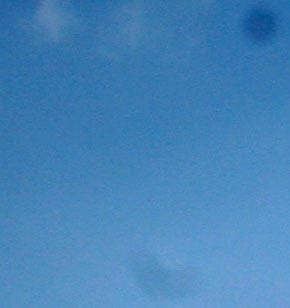 100% enlargement of highlighted area in above image at right reveals two spots caused by dust on a DSLR's sensor