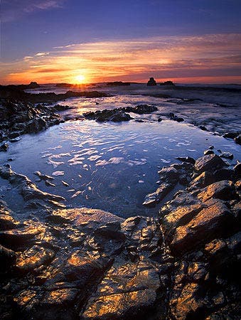 pool of water rocks sunset