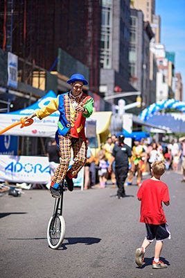 Adorama Street Fair in 2011, clown on stilts and child